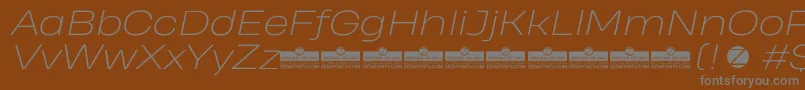 フォントHeadingProWideExtralightItalicTrial – 茶色の背景に灰色の文字
