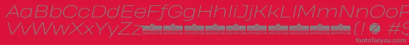 Czcionka HeadingProWideExtralightItalicTrial – szare czcionki na czerwonym tle