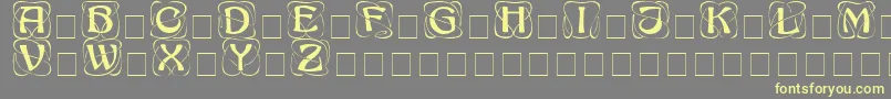 AdageDisplayCapsSsi-fontti – keltaiset fontit harmaalla taustalla