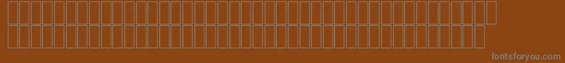 Fonte AgaMashqRegular – fontes cinzas em um fundo marrom