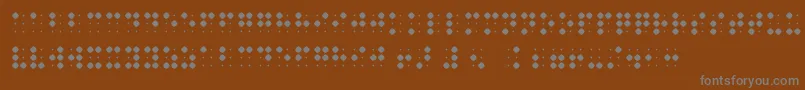 BraillenumBold-fontti – harmaat kirjasimet ruskealla taustalla
