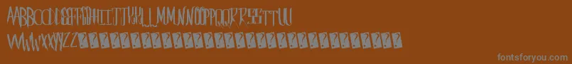 Czcionka Saberhusk – szare czcionki na brązowym tle
