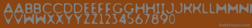 Dogfighter-fontti – harmaat kirjasimet ruskealla taustalla