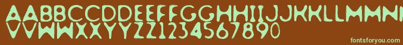 フォントDogfighter – 緑色の文字が茶色の背景にあります。
