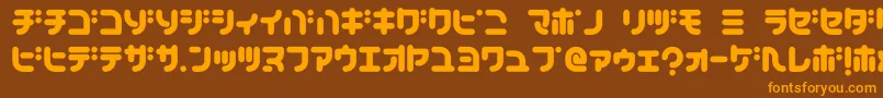 フォントTeacherK – オレンジ色の文字が茶色の背景にあります。