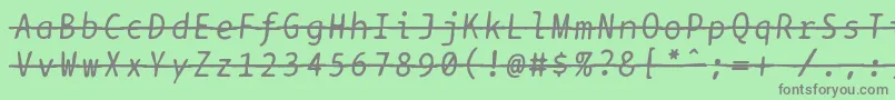 Bptypewritedamagedstrikethroughitalics-fontti – harmaat kirjasimet vihreällä taustalla