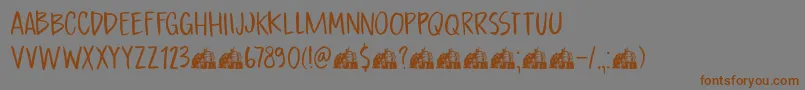 フォントDkBoardingHouseI – 茶色の文字が灰色の背景にあります。