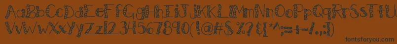 フォントKbwitchinghour – 黒い文字が茶色の背景にあります