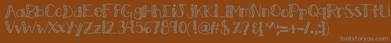 フォントKbwitchinghour – 茶色の背景に灰色の文字