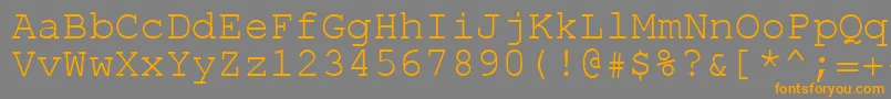フォントRolk8c – オレンジの文字は灰色の背景にあります。