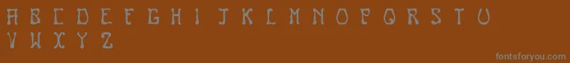 フォントNouveau – 茶色の背景に灰色の文字
