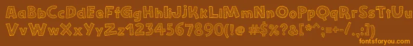 StefanieDots-fontti – oranssit fontit ruskealla taustalla