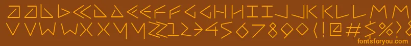 フォントUncialfifty – オレンジ色の文字が茶色の背景にあります。