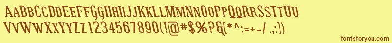 フォントCovingtonScRevBoldItalic – 茶色の文字が黄色の背景にあります。