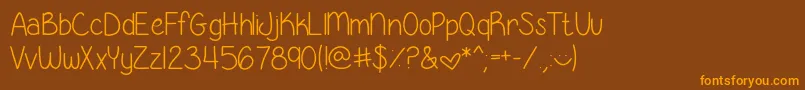GeorgiaBelleSkinny-Schriftart – Orangefarbene Schriften auf braunem Hintergrund