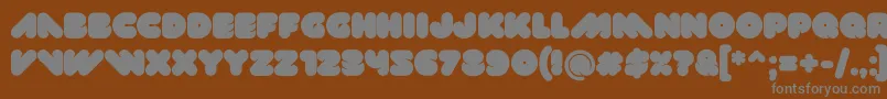 Val-fontti – harmaat kirjasimet ruskealla taustalla