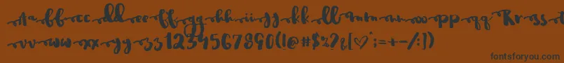フォントJustinroad – 黒い文字が茶色の背景にあります