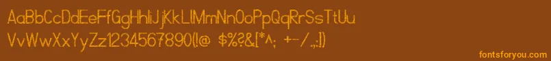 フォントScrfibbleRegular – オレンジ色の文字が茶色の背景にあります。