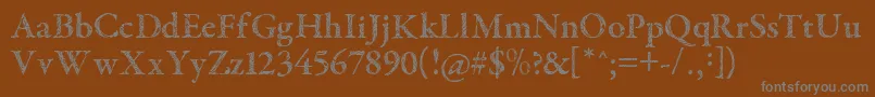 TribalGaramond-fontti – harmaat kirjasimet ruskealla taustalla