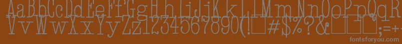 HandTypewriter-fontti – harmaat kirjasimet ruskealla taustalla