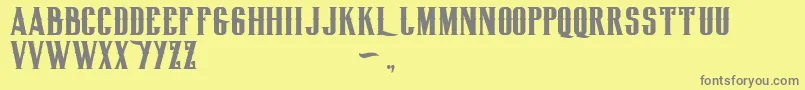 フォントBiglodgetypefree – 黄色の背景に灰色の文字