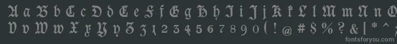 GoeschenGesperrtUnz1a-fontti – harmaat kirjasimet mustalla taustalla