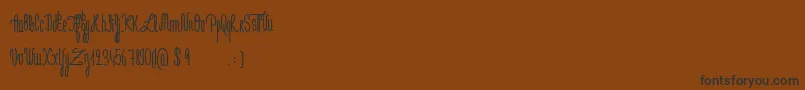 Czcionka JeNaimePasLeLundiBold – czarne czcionki na brązowym tle
