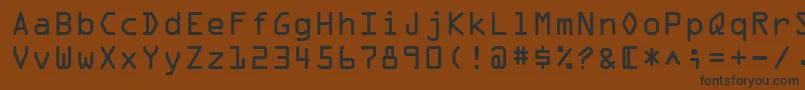 フォントOcrOnectt – 黒い文字が茶色の背景にあります