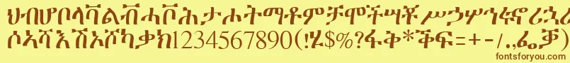 フォントGeeztimesssk – 茶色の文字が黄色の背景にあります。