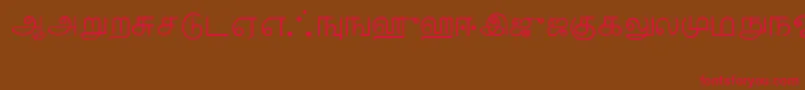 フォントTamil – 赤い文字が茶色の背景にあります。