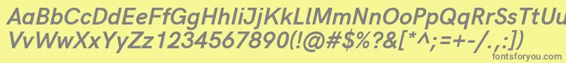 HkgroteskBolditalic-fontti – harmaat kirjasimet keltaisella taustalla