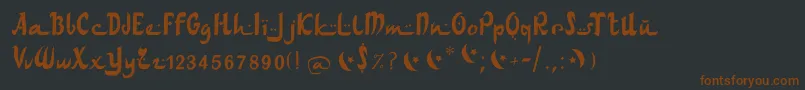 フォントArabdancesmediumitalic – 黒い背景に茶色のフォント