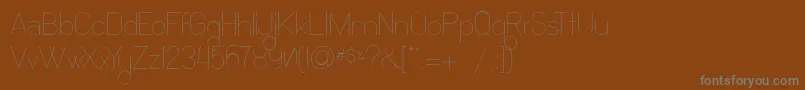 OchoSiete-fontti – harmaat kirjasimet ruskealla taustalla