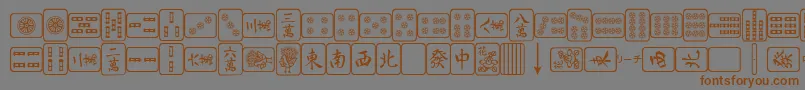 フォントMahjongPlain – 茶色の文字が灰色の背景にあります。