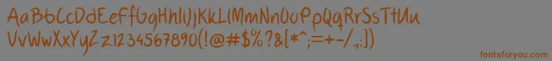 フォントFpThirdHand – 茶色の文字が灰色の背景にあります。