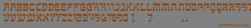 フォントKanisah – 茶色の文字が灰色の背景にあります。