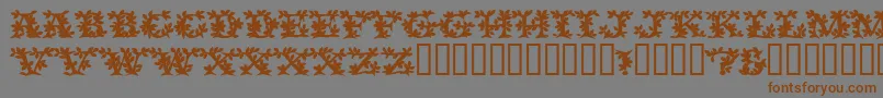 フォントVinecapssskBold – 茶色の文字が灰色の背景にあります。