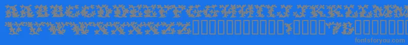 フォントVinecapssskBold – 青い背景に灰色の文字