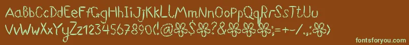 フォントSuwikisu – 緑色の文字が茶色の背景にあります。