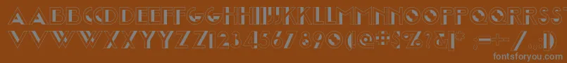 Joostamillionairenf-fontti – harmaat kirjasimet ruskealla taustalla