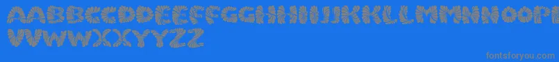 Marmeladpersonaluse-fontti – harmaat kirjasimet sinisellä taustalla