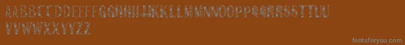 Sanromero-fontti – harmaat kirjasimet ruskealla taustalla