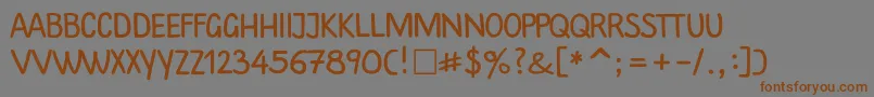 フォントPlainscriptctt – 茶色の文字が灰色の背景にあります。