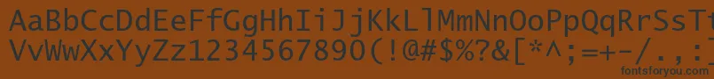 フォントLucidasanstypewriterstd – 黒い文字が茶色の背景にあります