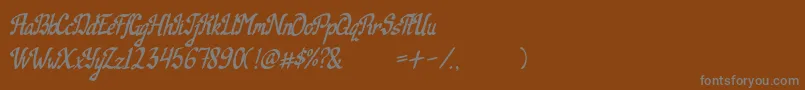 Weitere Informationen zur Camille-Schriftart Camille-Schriftart – Graue Schriften auf braunem Hintergrund