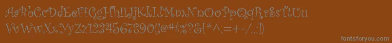 Kuritza-Schriftart – Graue Schriften auf braunem Hintergrund