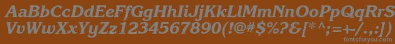 Karlajohnson7Extraboldcursivesh-fontti – harmaat kirjasimet ruskealla taustalla