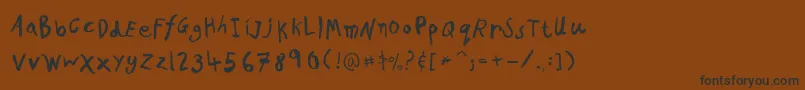 フォントPfkidsproGradethree – 黒い文字が茶色の背景にあります