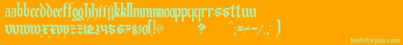 TheArtOfIlluminating-Schriftart – Grüne Schriften auf orangefarbenem Hintergrund