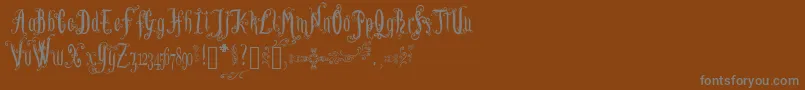 LutinPaniquangoisse-Schriftart – Graue Schriften auf braunem Hintergrund
